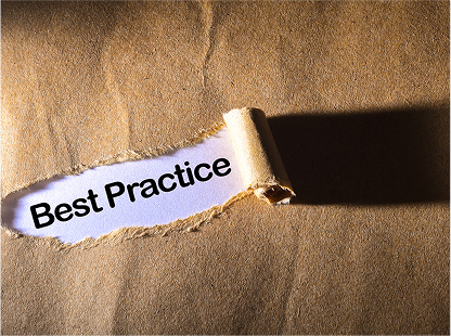 Smiling woman on laptop in a cozy kitchen